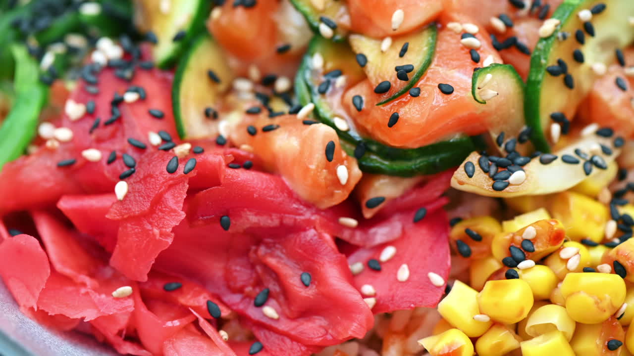 Close view of poke with vegetables, seeds and seafood in a bowl