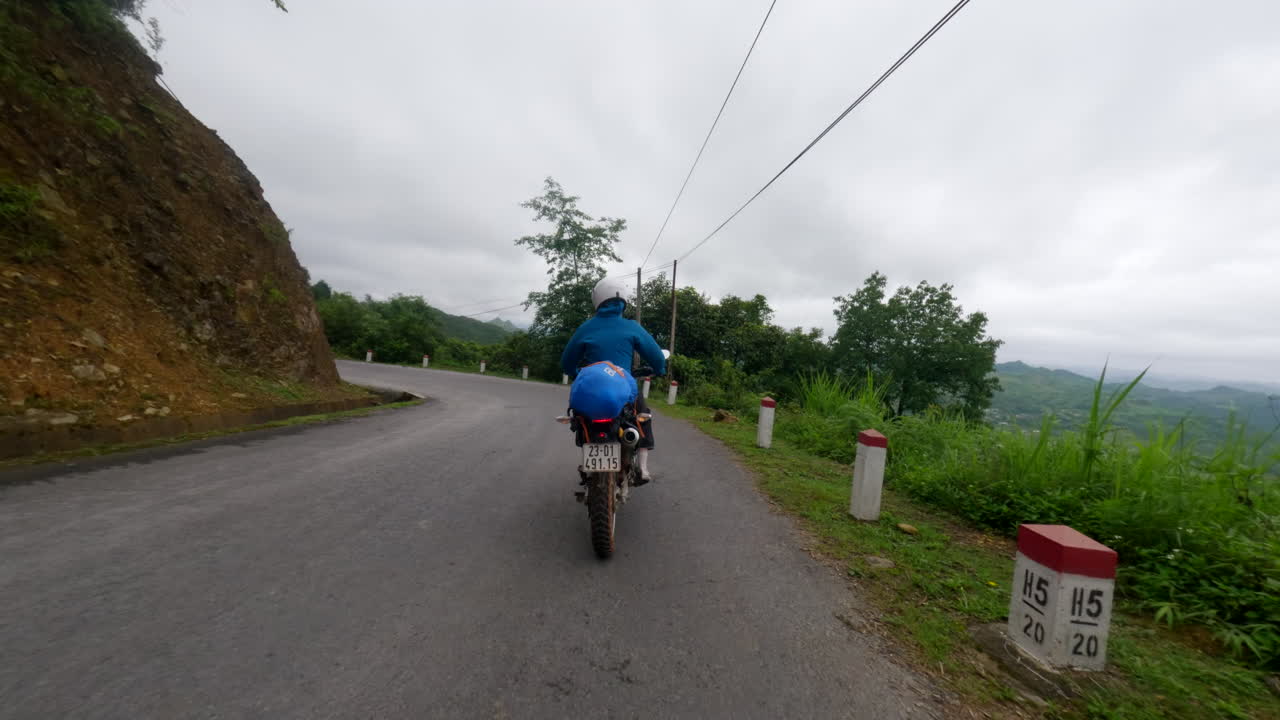 Following A Motorcycle Driving Across The Ha-Giang Loop In Northern Vietnam. Tracking Shot