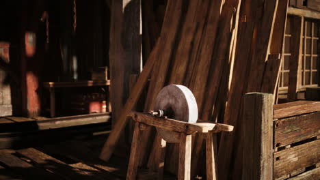 a rustic wooden grinding wheel in a workshop