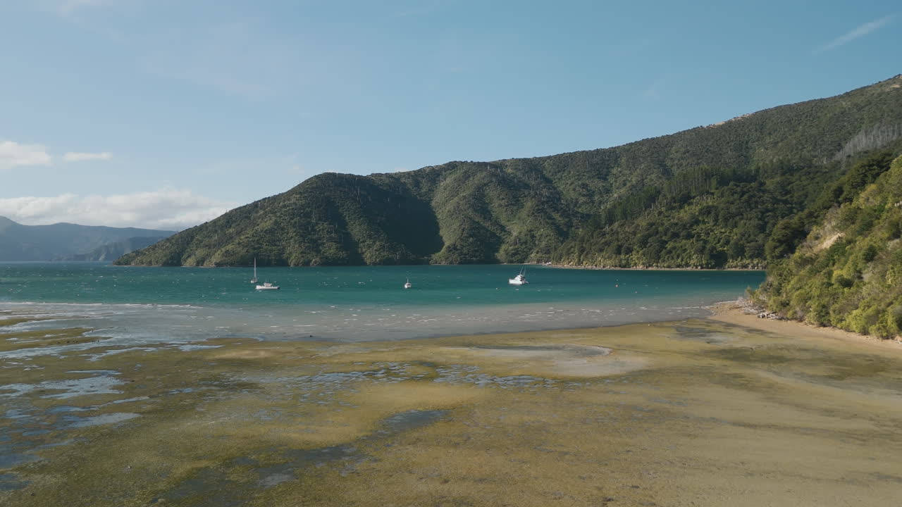 Coastal Bay with Boats and Mountains