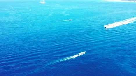 cruise ships sailing across the bright blue ocean during a beautiful sunny day