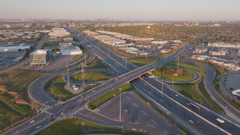 wide aerial view of highway 401 in mississauga, canada, slow motion, capturing the bustling roads and surrounding industrial buildings