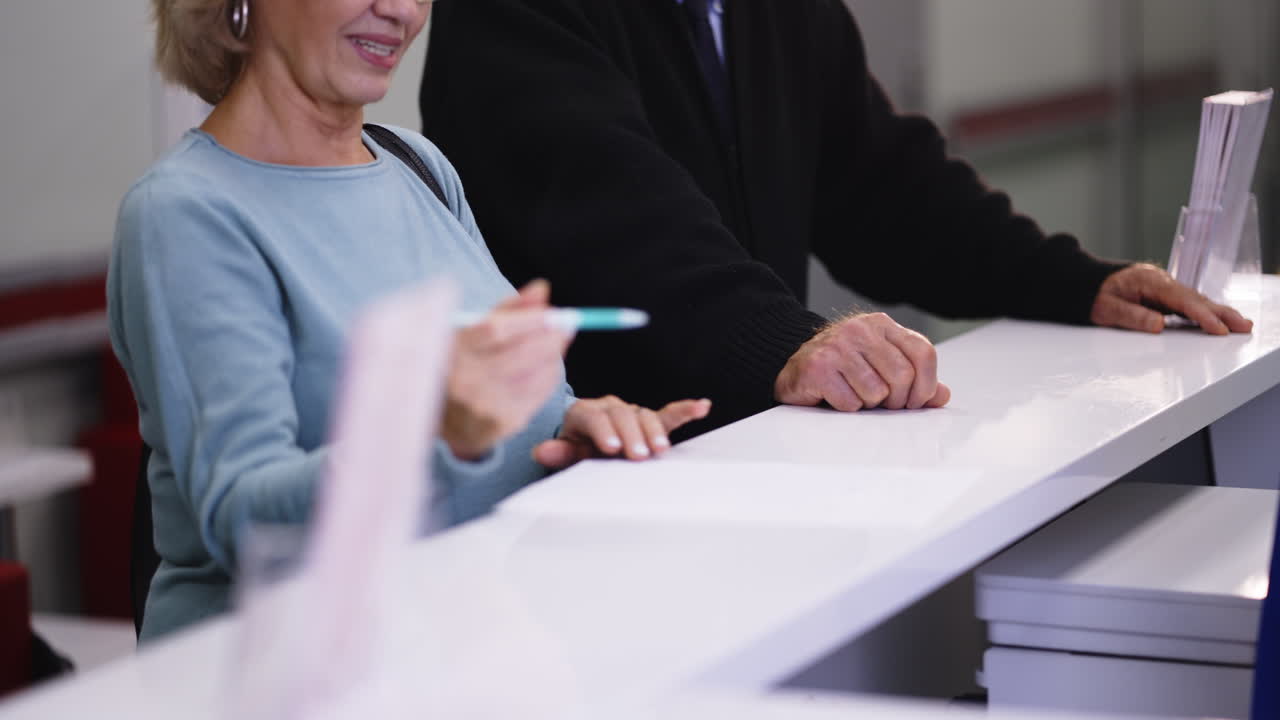 People at Reception Filling Out Form