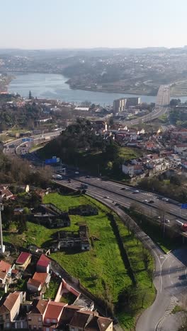 aerial view of a city with a river and highway