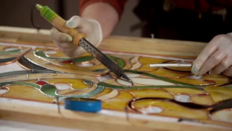 stained glass artist working on a piece