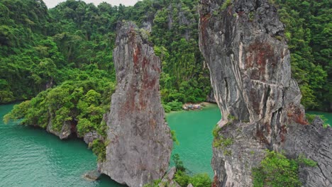 aerial drone panning around kudu island limestone rocks with views of ko kudu yai island in thailand's national park