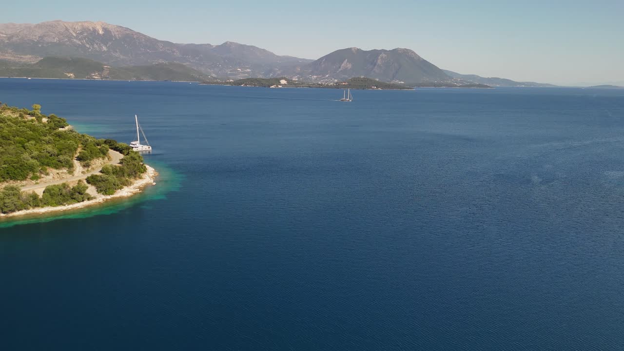 Ionian Sea aerial in Greece: two-masted ship motors between islands