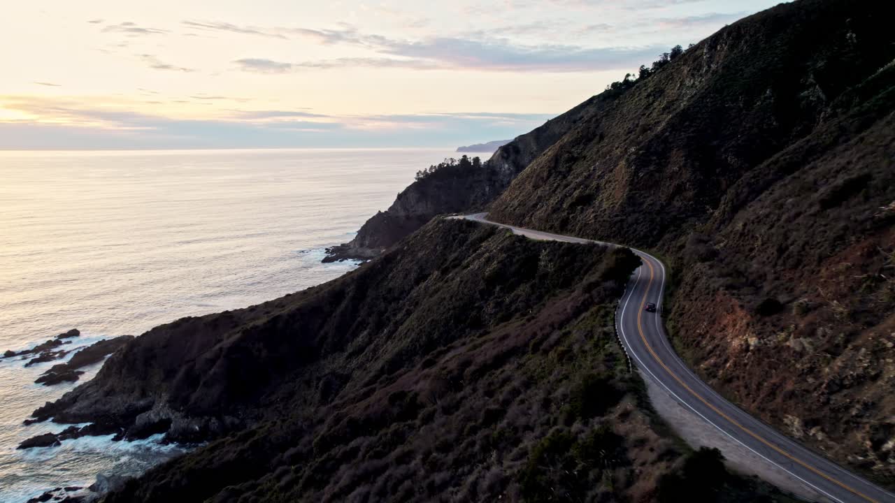 Aerial View of Bixby Bridge in Big Sur California Overlooking the Pacific Ocean With Car At Sunset