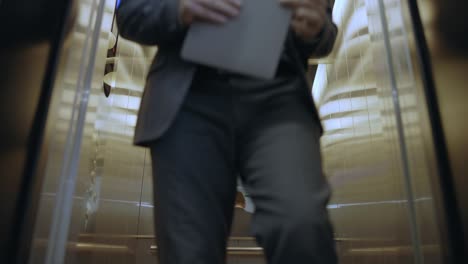 corporate employees talking and exiting elevator, atmosphere in office building