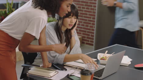 young black business woman team leader showing colleague project research on laptop computer screen sharing creative ideas in diverse office workplace