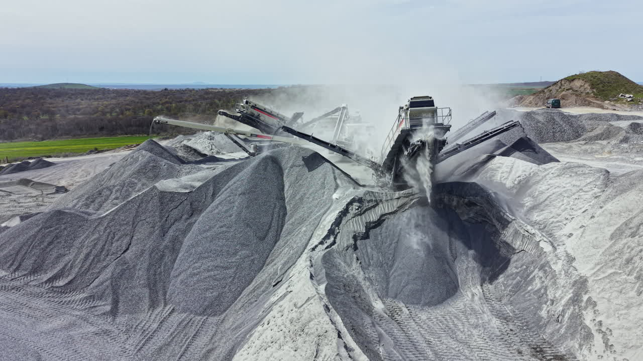 Granite quarry operation showing machinery processing rock in a large pit during daylight