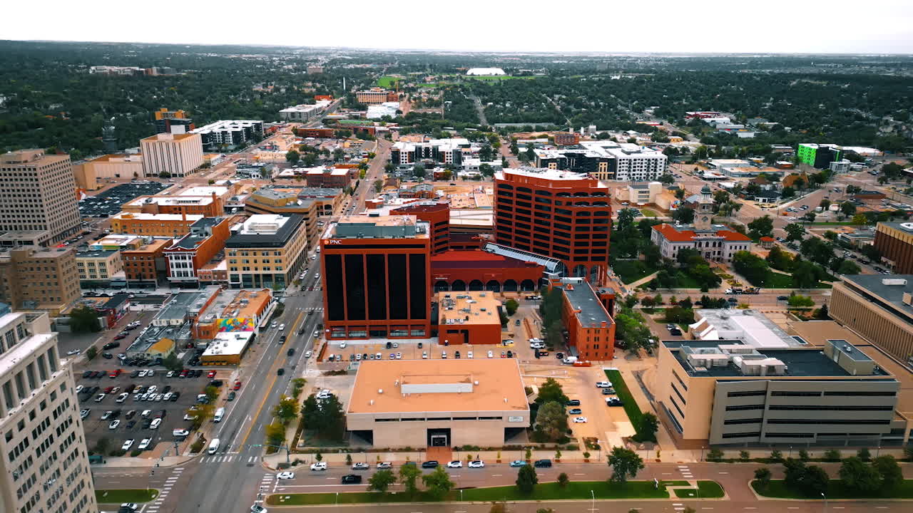 Colorado Springs, USA, 22 July 2025: Plaza of the Rockies office buildings in Colorado-Springs, Colorado, USA. Drone footage over the city. Lush greenery at backdrop