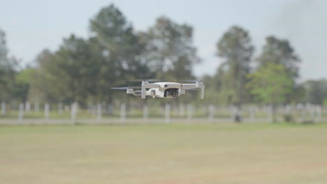 drone flying outdoor hovering mid air, spinning on its axis in a open country side