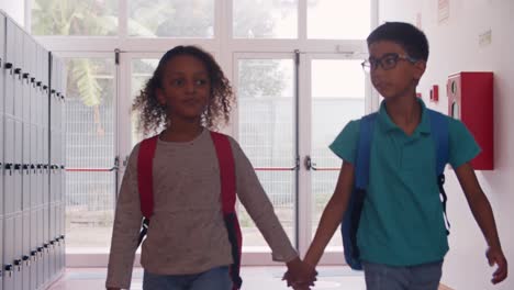 diverse school friends walking in school corridor