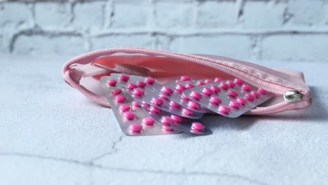 pink pills in a pink pouch