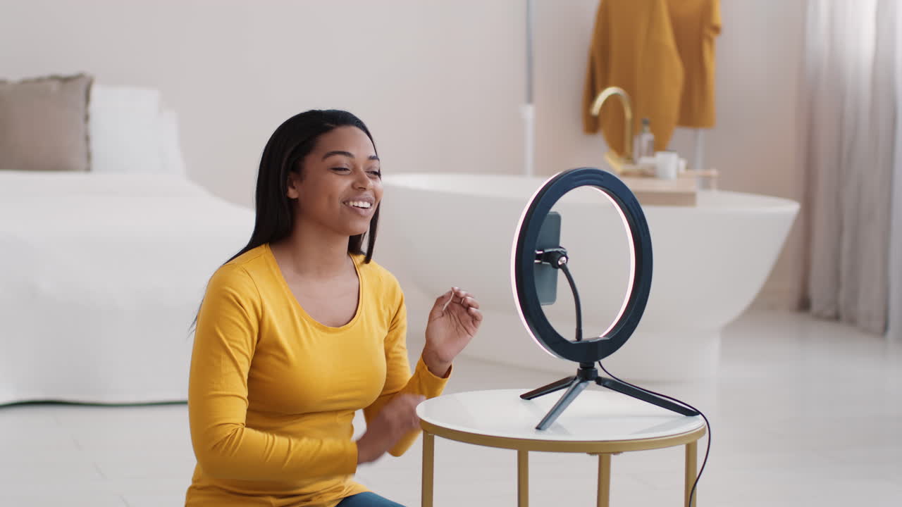 Woman using ring light for social media video