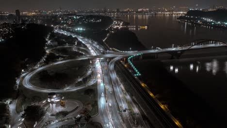 Aerial-hyperlapse-flight-over-guandu-interchange-and-guandu-bridge-at-night