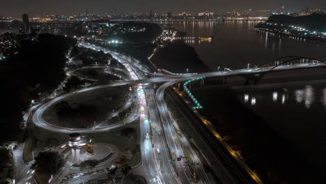 aerial hyperlapse flight over guandu interchange and guandu bridge at night