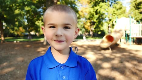 Portrait-of-mischievous-little-boy-on-playground