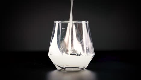 milk fills a glass in a steady stream