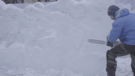 ice sculptor carving a large ice wall