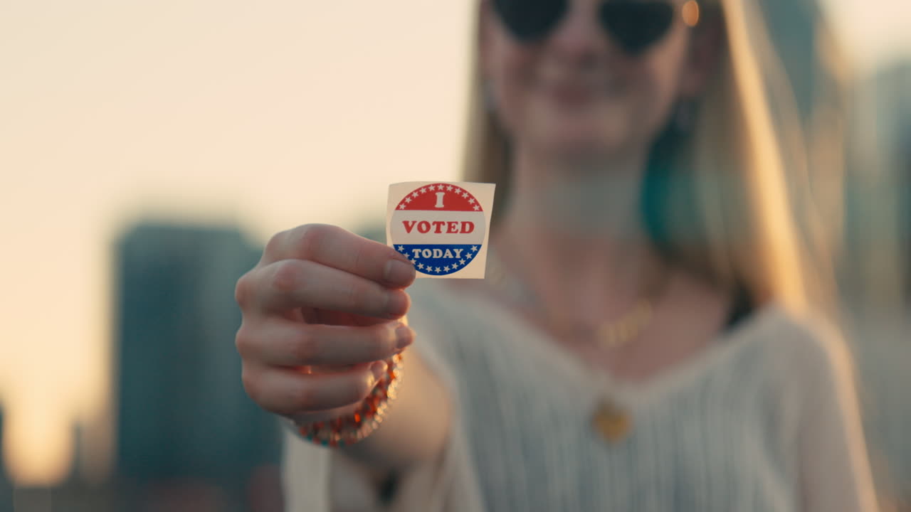 Woman holding an I Voted sticker
