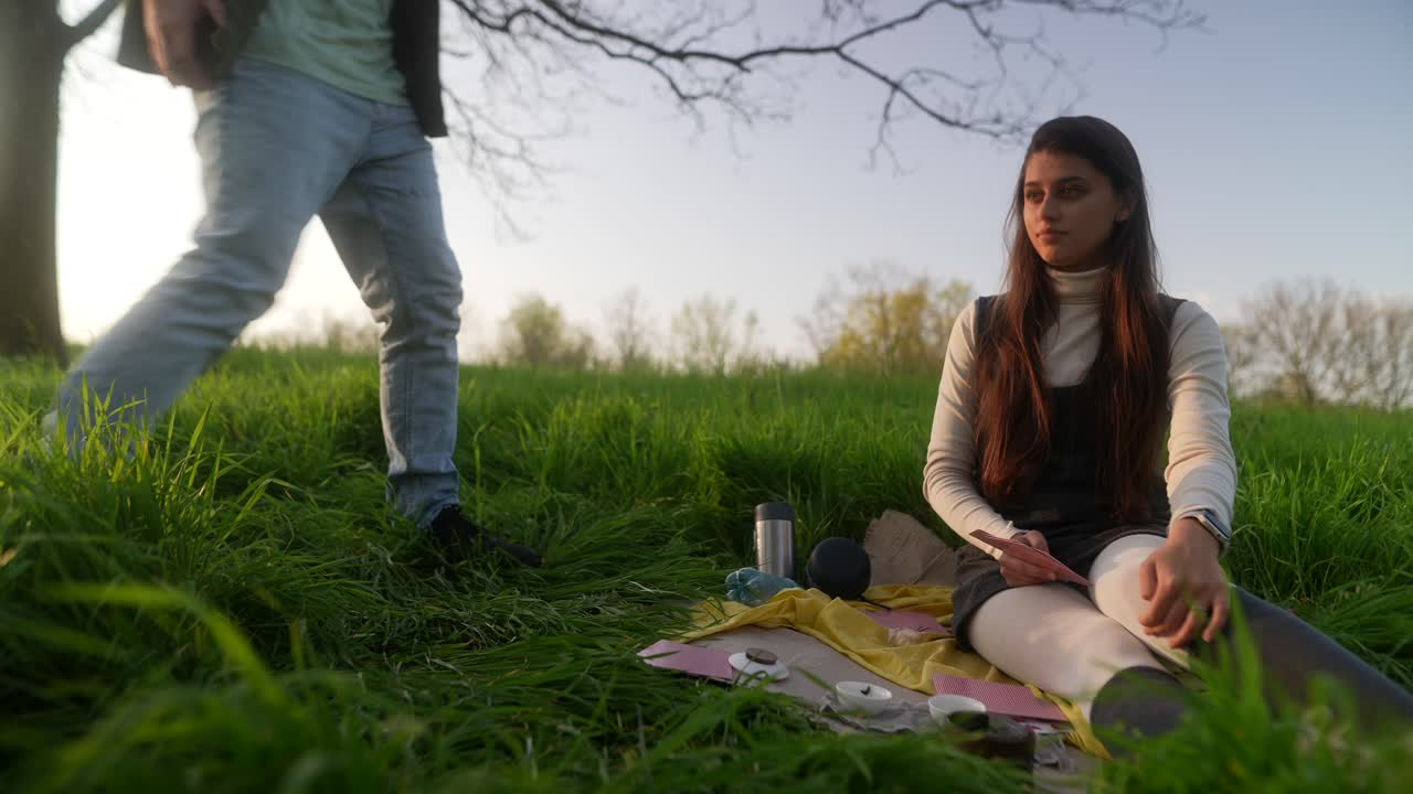Couple Having a Tarot Reading in a Park