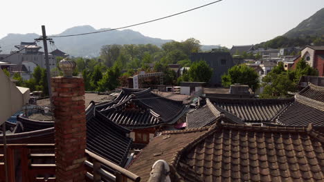 roof tops of hanoks in historic  bukchon neighborhood in seoul, south korea with micro dust in background.