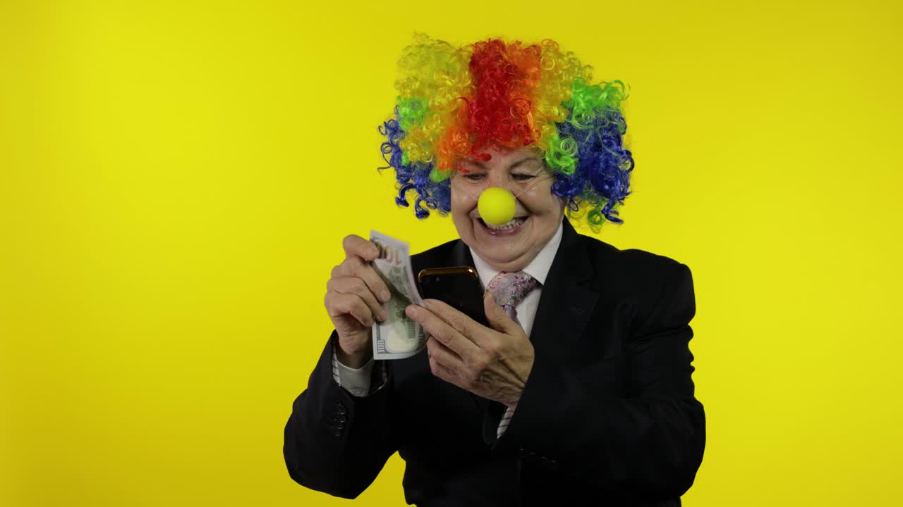 payaso mujer de negocios independiente recibe ingresos monetarios mientras usa el teléfono inteligente