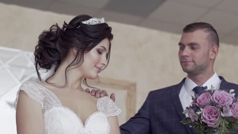 slow-motion-closeup-young-fiance-touches-bride-open-shoulder