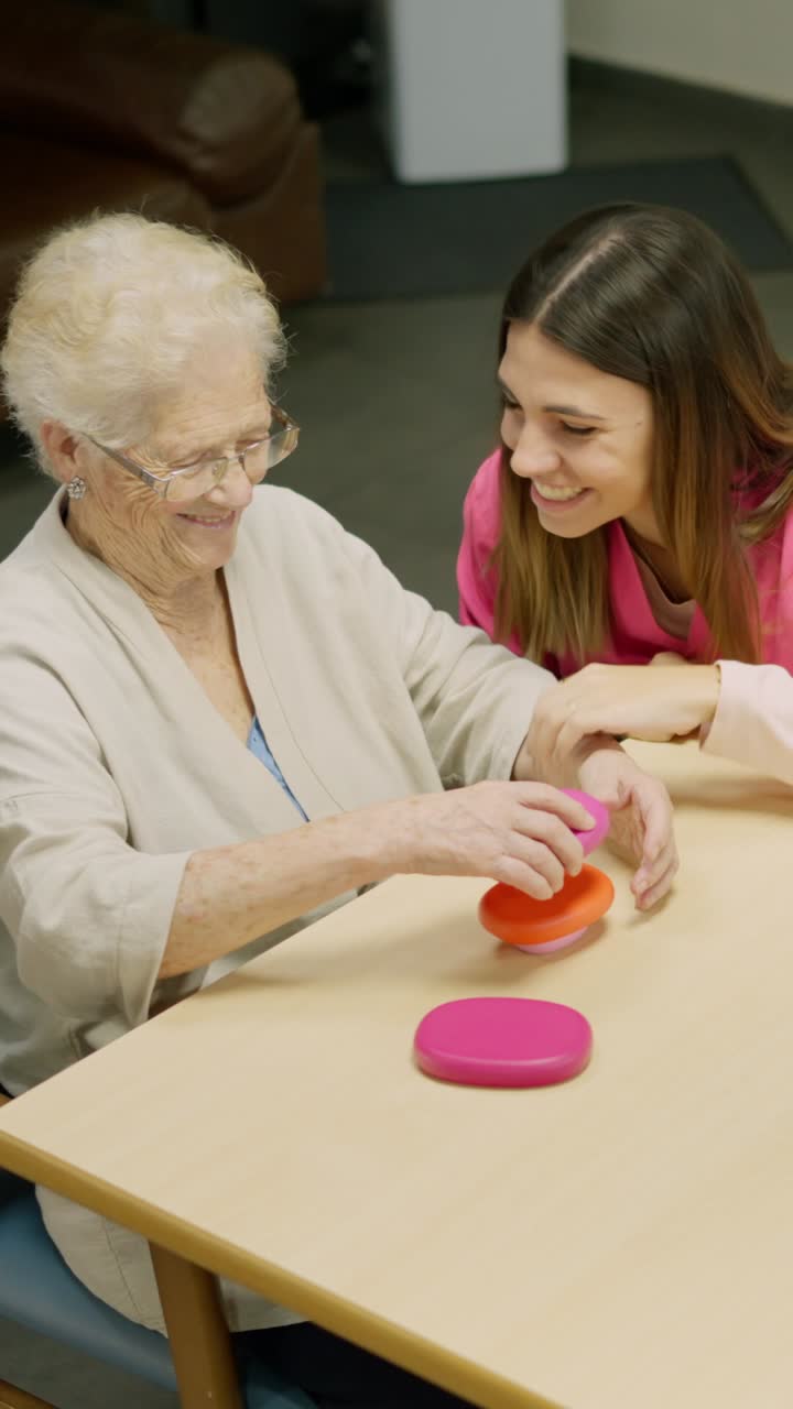 Elderly Woman and Caregiver Engaging in Cognitive Activity