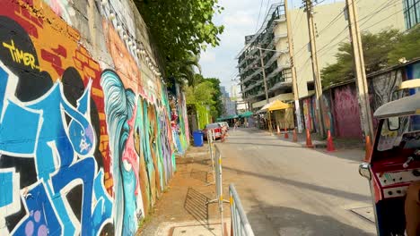 vibrant street art with passing tuk-tuk vehicle