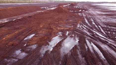 Tire-tracks-and-peat-deposits-in-rural-area-of-Latvia,-aerial-drone-view