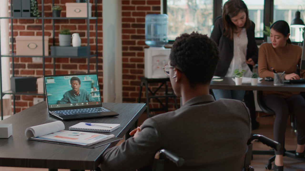 Person in wheelchair attending business meeting on videocall