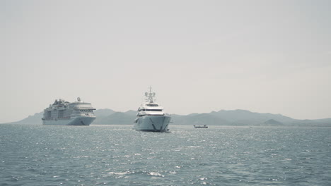 cruise ship and yacht at sea