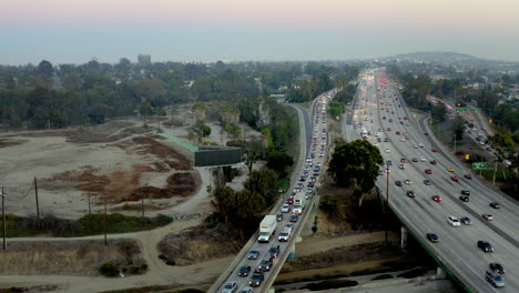 aerial view of heavy traffic on a congested highway at dusk with fire truck