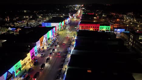 rochester, michigan skyline at night lit up with christmas lights on buildings and drone video moving forward