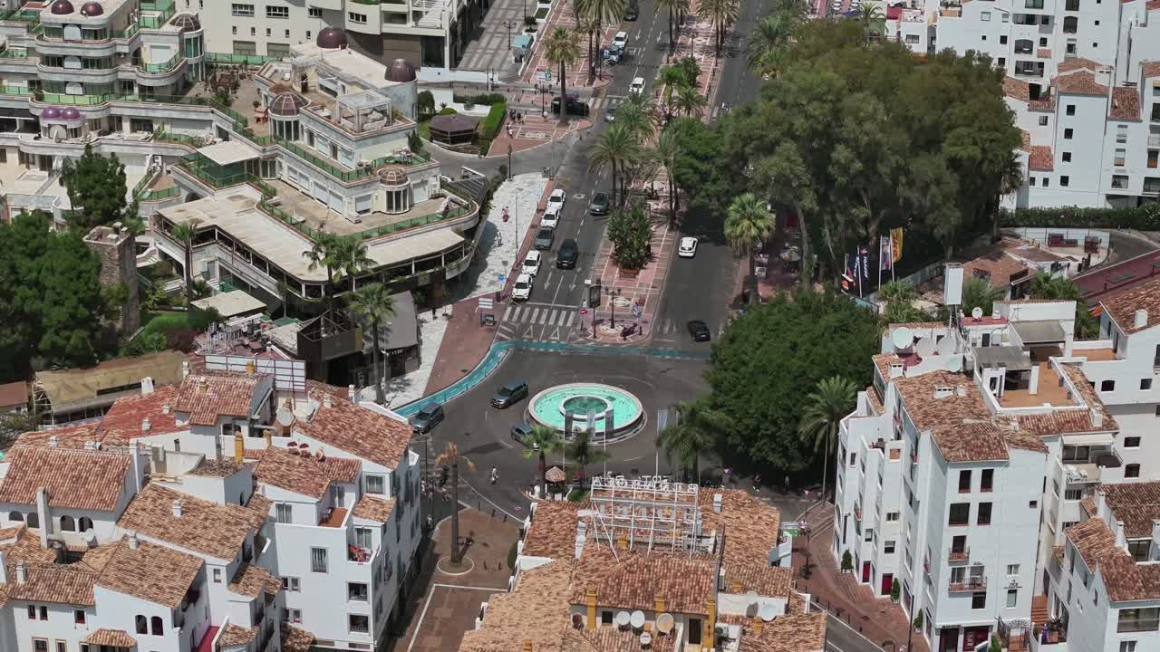 Aerial view of Marbella, Spain, highlighting its Mediterranean streets, terracotta rooftops, and palm-lined avenues, capturing the charm and elegance of the coastal cityscape