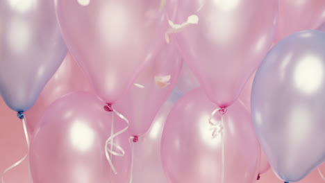 confetti falling  in slow motion pink and blue balloons background - red epic dragon