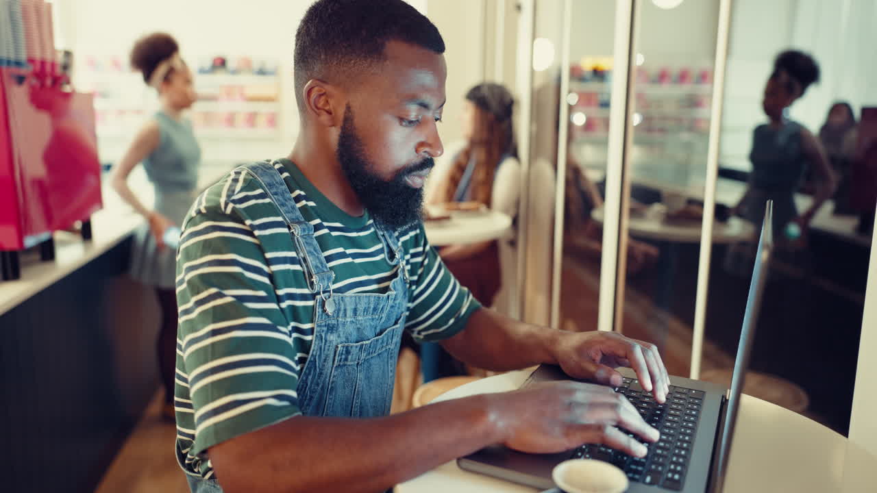 Cafe, creative and black man with a laptop