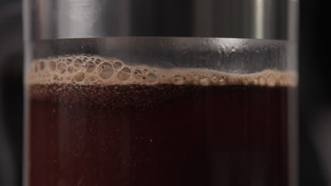 close-up of coffee brewing in a french press