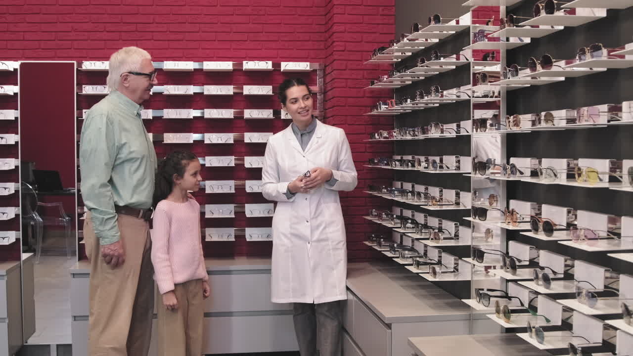Senior Man With Granddaughter In Optical Store
