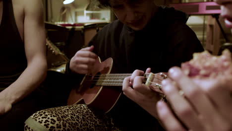 medium shot of a man playing the guitar