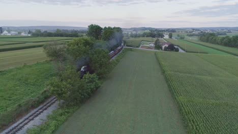 Aerial-View-on-an-Approaching-Steam-Passenger-Train-in-the-Amish-Countryside-on-a-Summer-Day