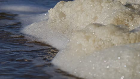 foamy water waves crash near the oosterschelde storm surge barrier in zeeland, super slow motion