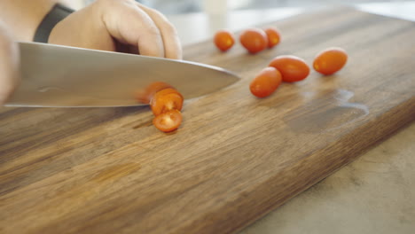 cutting tomato’s on a walnut cutting board