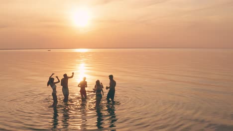 the young people having fun and dancing on the water