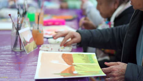 elder finger painting retired residence