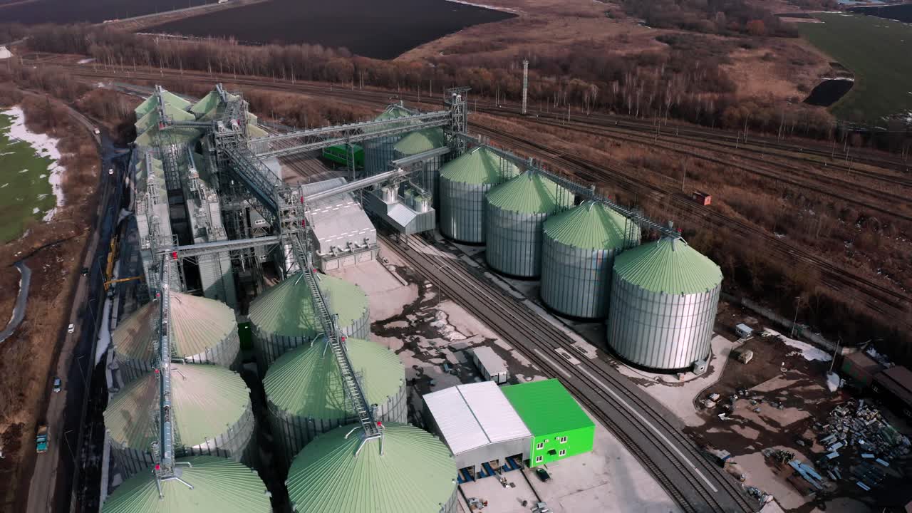 silos metálicos en el campo vista aérea. grandes contenedores para el almacenamiento y procesamiento de granos. ascensores de grano de plata en tierras de cultivo. tanque de almacenamiento vista desde arriba. silo con grano.