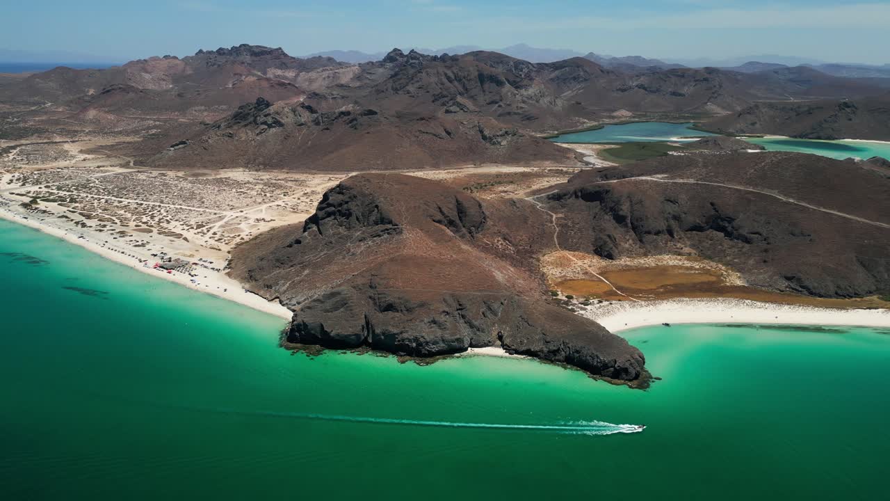 Coastline aerial shot of turquoise water meeting rocky mountains near La Paz, Mexico